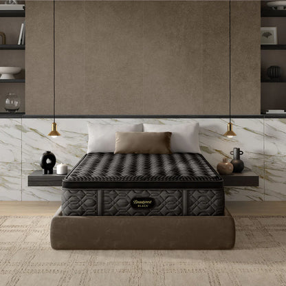Black mattress on a bed in a modern bedroom setting with neutral colors.