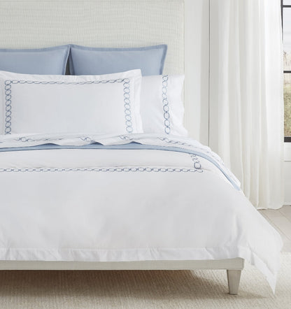 SFERRA bedding on a made bed in a bedroom