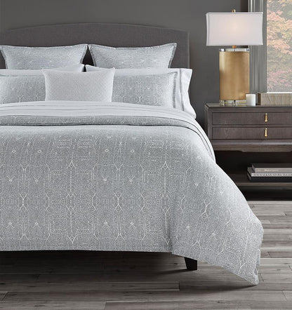 SFERRA bedding on a made bed in a bedroom