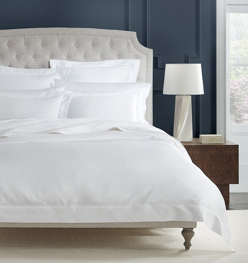 SFERRA bedding on a made bed in a bedroom