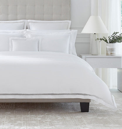 SFERRA bedding on a made bed in a bedroom