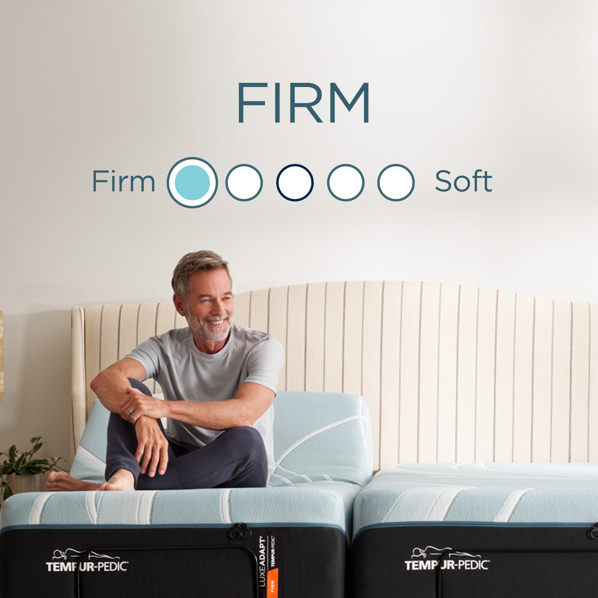 Man sitting comfortably on Tempur-Pedic LuxeAdapt® Firm mattress with graphic indicating firm feel—ideal for sleepers needing solid support and alignment.