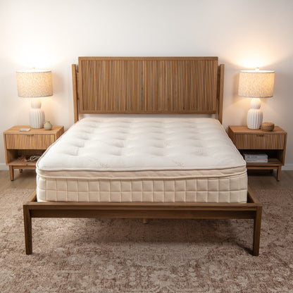 Naturepedic Concerto Organic Pillow Top Mattress on a wood bed in a bedroom