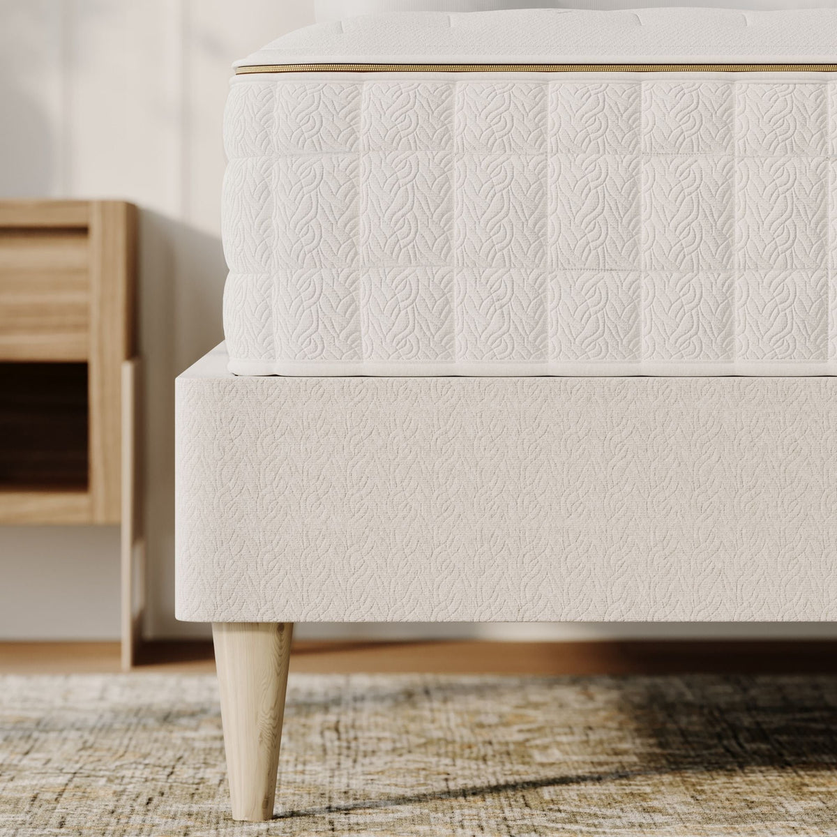 Side view of the Naturepedic EOS Classic Organic Mattress on a bed