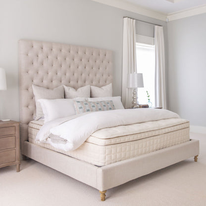 Naturepedic EOS Pillow Top Organic Mattress on an upholstered bed in a bedroom