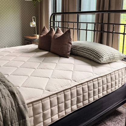 Naturepedic Serenade Organic Hybrid Mattress - Firm on a bed in a bedroom