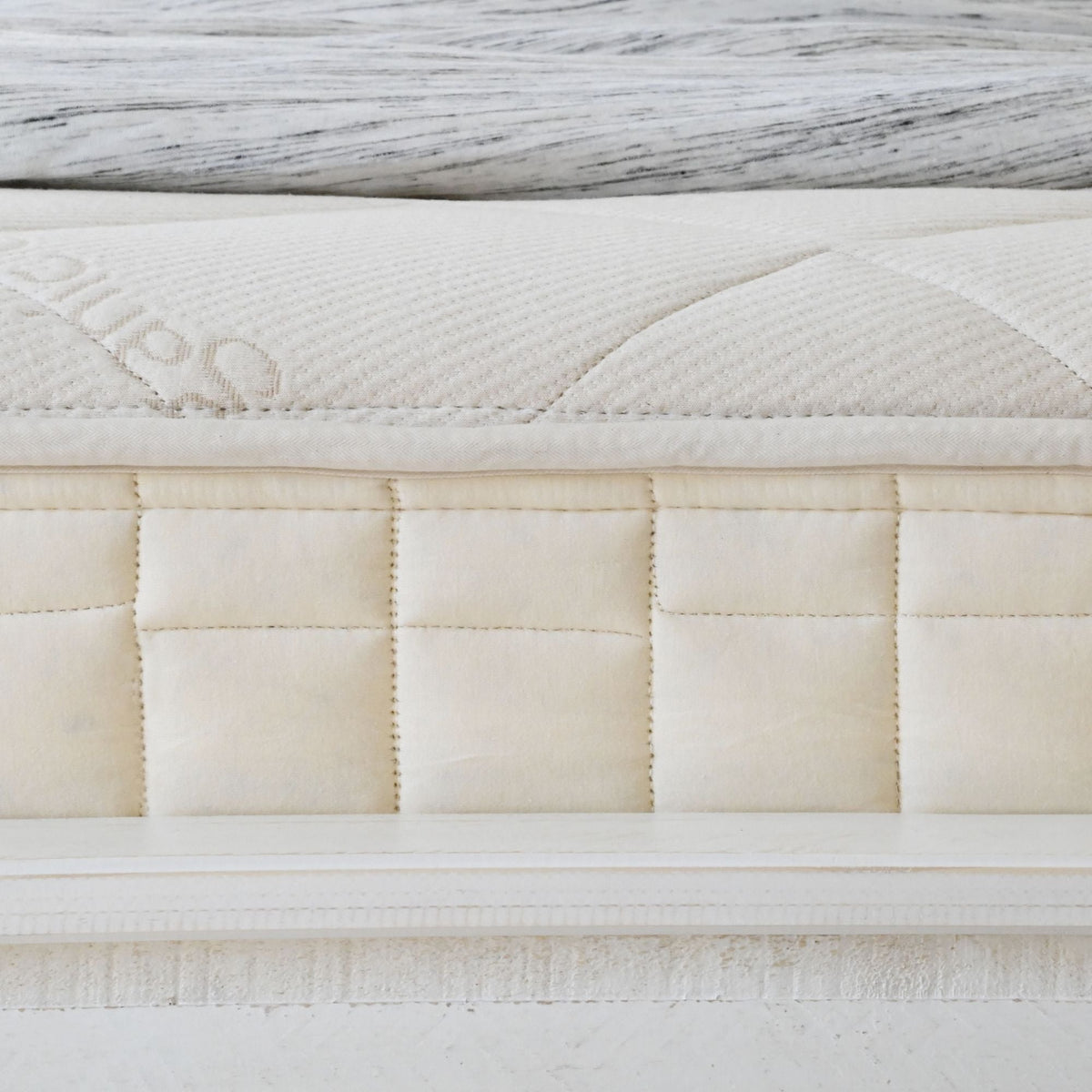 Quilted border detail of the Naturepedic Serenade Organic Hybrid Mattress - Cushion Firm