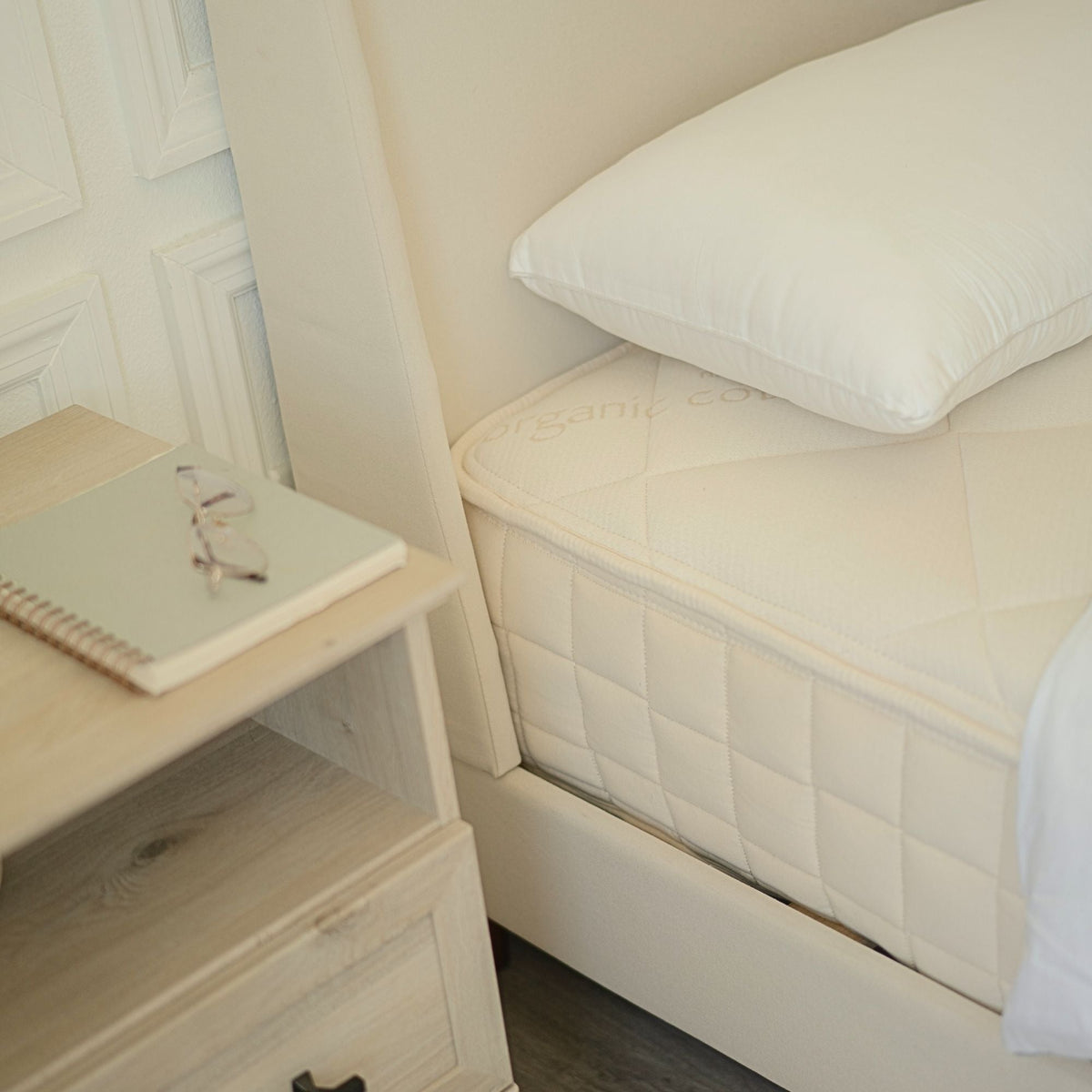 Naturepedic Serenade Organic Hybrid Mattress - Firm beside a nightstand