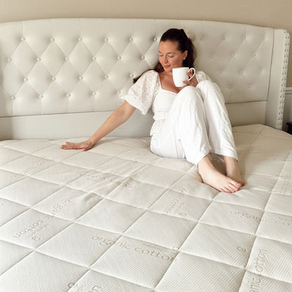 Woman sitting on a Naturepedic Serenade organic mattress