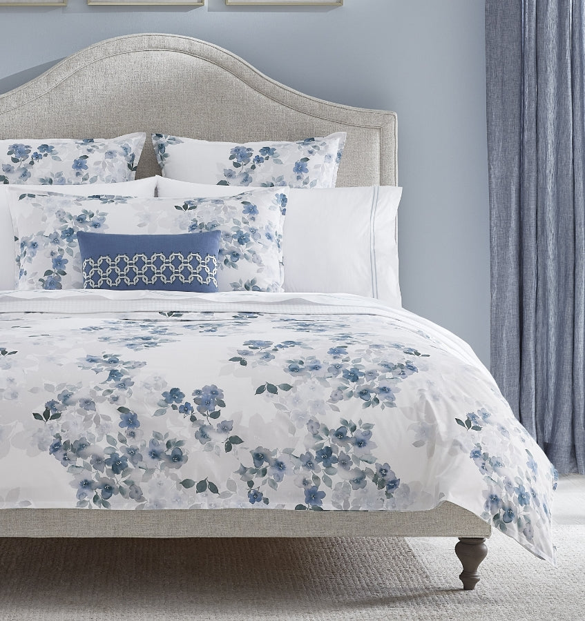 SFERRA bedding on a made bed in a bedroom