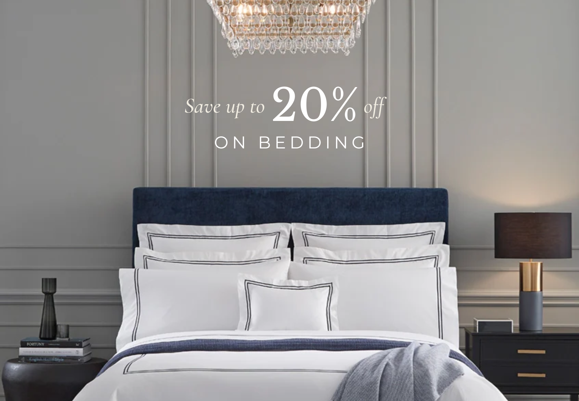 Bedroom with white bedding set, navy headboard, and promotional text for bedding sale.