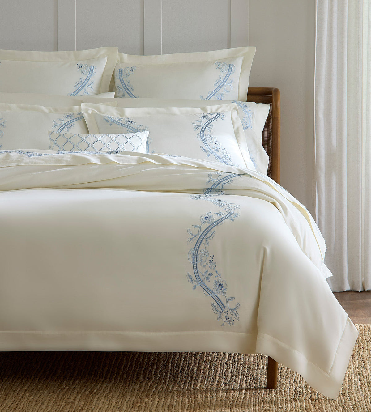 SFERRA bedding on a made bed in a bedroom