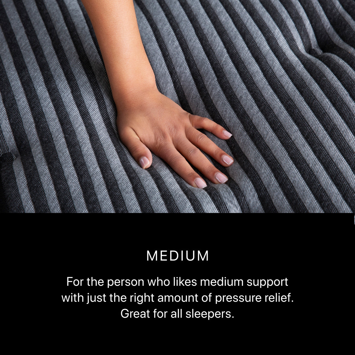 Hand pressing Beautyrest Black Series One Medium mattress surface – medium comfort feel with balanced support and pressure relief.