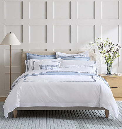 SFERRA bedding on a made bed in a bedroom