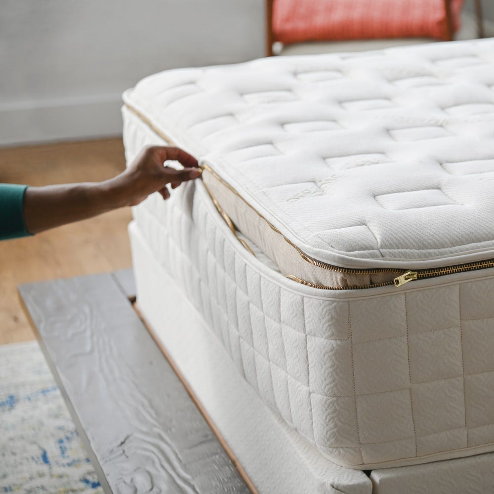 Zippered cover being opened on the Naturepedic EOS Classic Organic Mattress