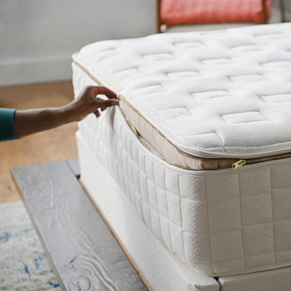 Zippered cover being opened on the Naturepedic EOS Classic Organic Mattress