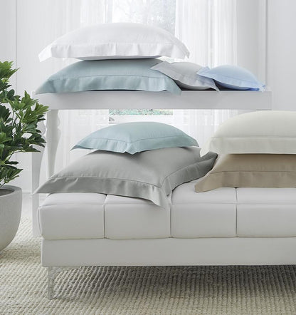 SFERRA bedding on a made bed in a bedroom