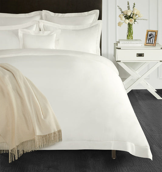 SFERRA bedding on a made bed in a bedroom