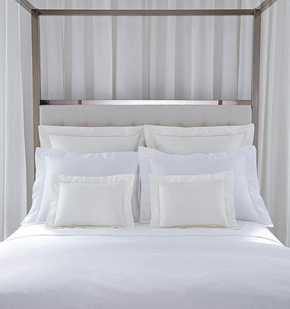 SFERRA bedding on a made bed in a bedroom