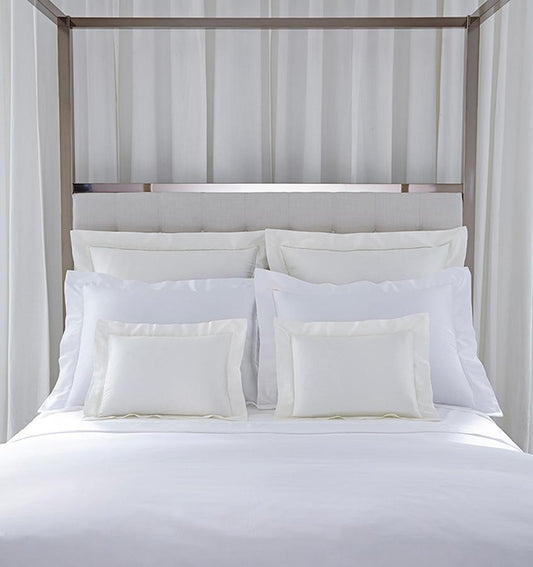 SFERRA bedding on a made bed in a bedroom