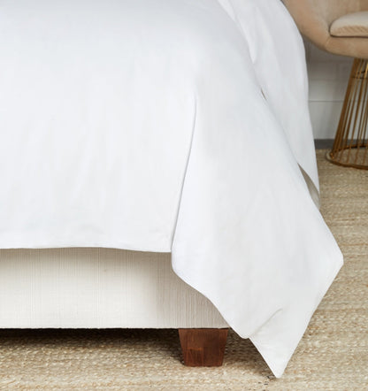 SFERRA bedding on a made bed in a bedroom