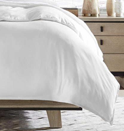 SFERRA bedding on a made bed in a bedroom