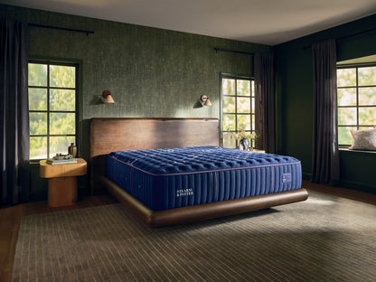 Stearns & Foster Legacy Firm Tight Top II mattress in a styled bedroom, three-quarter view